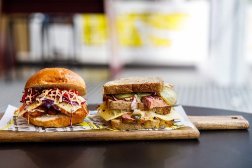 Joey Zaza's Boss Chick in burger bun (left) and a double The Jayzee Reuben in square pullman bread (right).