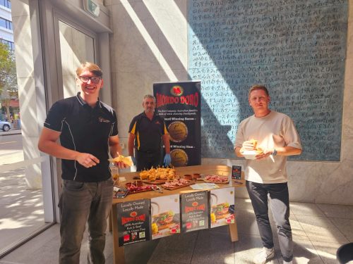 The Mondo Doro team posing with Loaded Conti rolls filled with Mondo Doro cold cuts during Joey Zaza's 2025 birthday and food tasting event