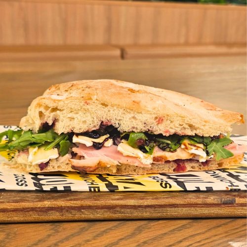 The HamBrie is a holiday-themed ham-and-cheese sandwich featuring slices of Christmas ham, cranberry, and brie.